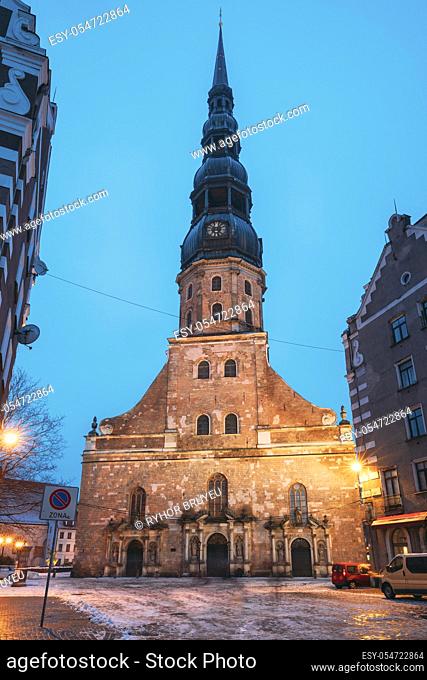 Riga, Latvia. Night View Of St. Peter's Church In Old Town Riga Latvia. Illuminated Street