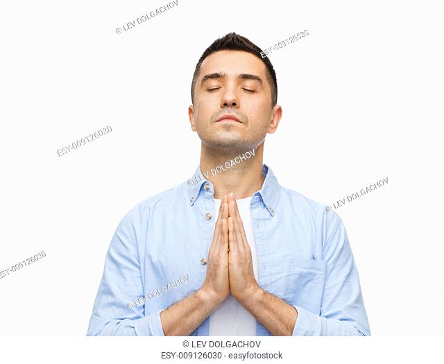 faith in god, religion and people concept - happy man with closed eyes praying