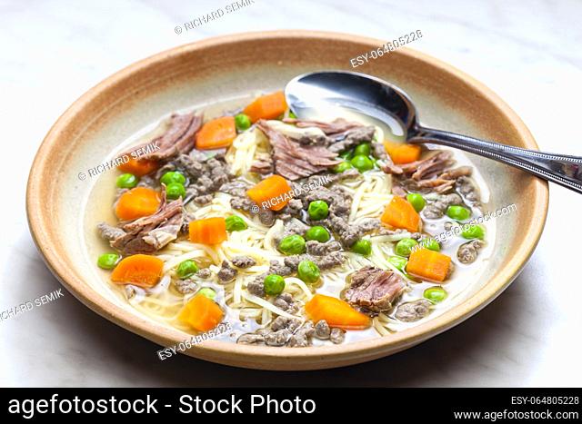 beef broth with green peas, carrot and small meatballs