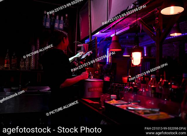 PRODUCTION - 07 October 2023, Berlin: A bartender serves a customer at the bar in Club Re:mise. Photo: Fabian Sommer/dpa. - Berlin/Berlin/Germany