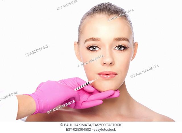 Beautiful face lip filler collagen injection Cosmetic spa beauty treatment with pink gloves, on white