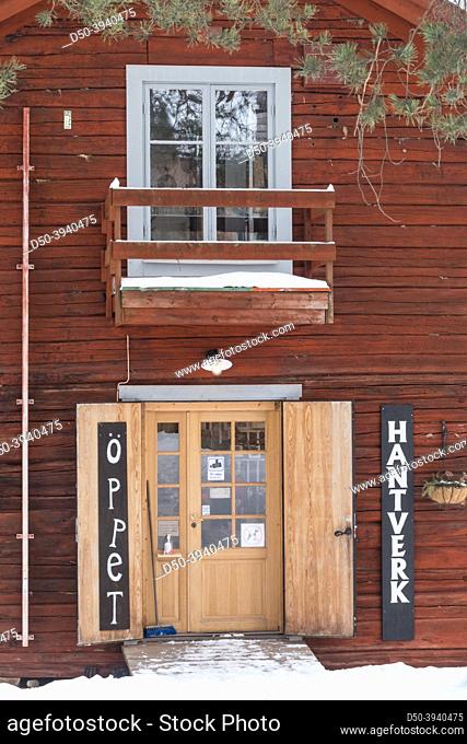 Sundsvall, Sweden Old buildings in the Norra Berget open air museum in the winter. An entrance to craft store. Sign in Swedish says: ""open, crafts