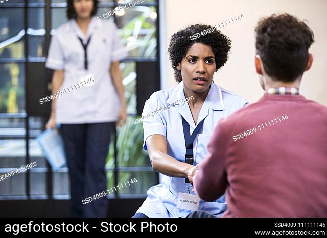 Portrait of Woman in healthcare industry having consultation with patient
