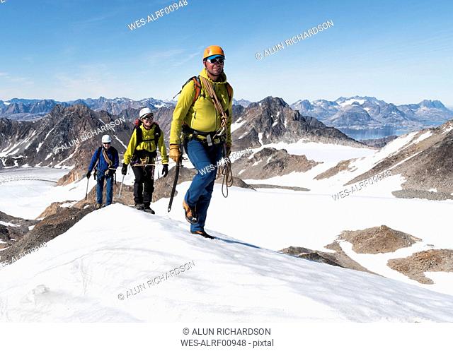 Greenland, Sermersooq, Kulusuk, Schweizerland Alps, mountaineers walking in snowy mountainscape