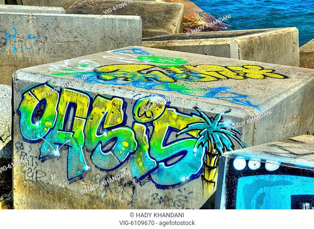 GRAFFITI ON CONCRETE BLOCKS AT A PIER AT BARCELONA BEACH SPAIN 02 - 27/04/2017