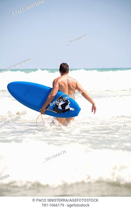 Boy surfing in a summer day
