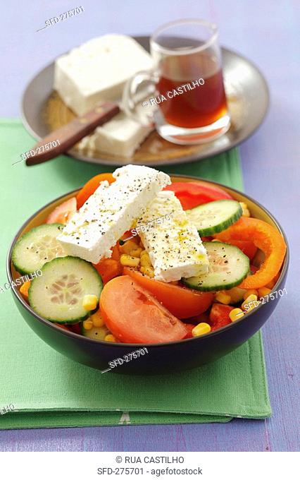 Sweetcorn, cucumber, tomato and red pepper salad with sheep's cheese