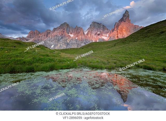 Baita Segantini, Pale of San Martino, Trento province, Dolomites, Trentino Alto Adige, Italy, Europe. Cimon della Pala reflected into a small lakes at sunset