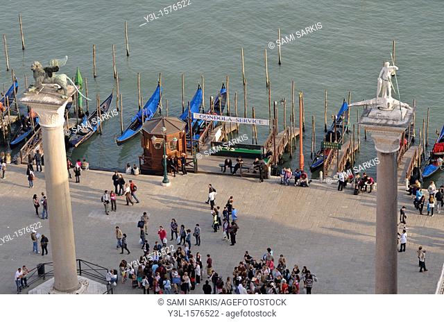 Columns of San Marco left and San Teodoro right by gondolas harbor, elevated view from the Campanile, Venice, Italy