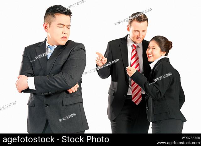 Business people (multi-ethnic) pointing their fingers on a colleague - mobbing