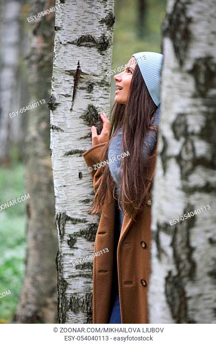 Beautiful brunette woman fashion portrait in birch forest