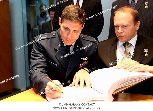 At the Gagarin Cosmonaut Training Center in Star City, Russia, Expedition 3738 Flight Engineer Michael Hopkins of NASA (left) signs a certification book in a...