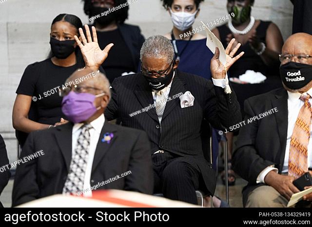 United States Representative Gregory Meeks (Democrat of New York), raises his hands as Amazing Grace is played during the ceremony for the late US...