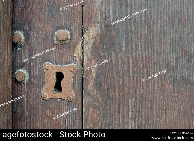Vintage keyhole in old wooden grunge door