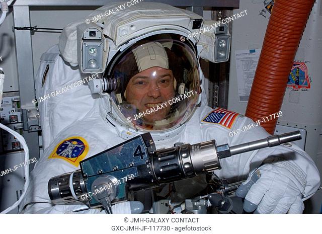 NASA astronaut Ron Garan, Expedition 28 flight engineer, checks out tools in the International Space Station's Quest airlock prior to the July 12 spacewalk he...