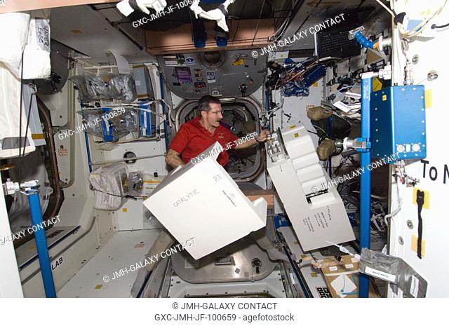 NASA astronaut Dan Burbank, Expedition 30 commander, works with Catalytic Reactor hardware in the Unity node of the International Space Station