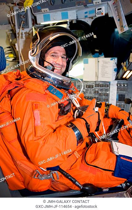 Astronaut George Zamka, STS-130 commander, attired in a training version of his shuttle launch and entry suit, occupies the commander's station during a...