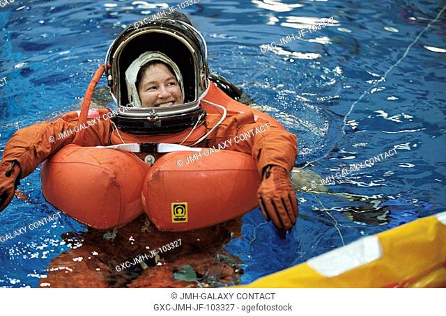 Astronaut Laurel B. Clark, STS-107 mission specialist, floats in water during an emergency egress training session in the Neutral Buoyancy Laboratory (NBL) near...