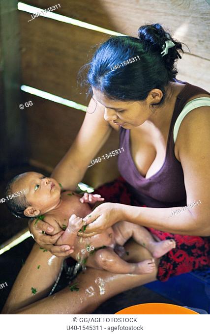 Mother bathing infant