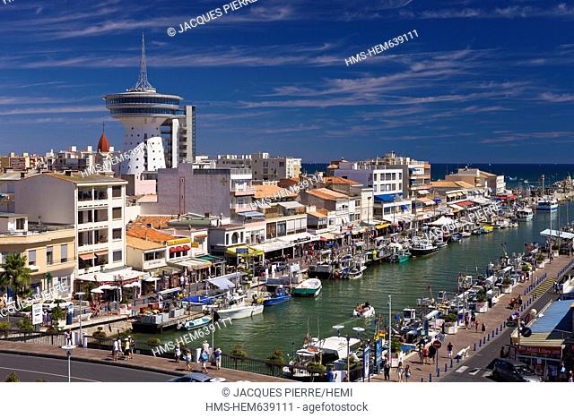 France, Herault, Palavas Les Flots, the canal which connects Lez coastal river with the sea and the former water tower converted into the Phare de la...