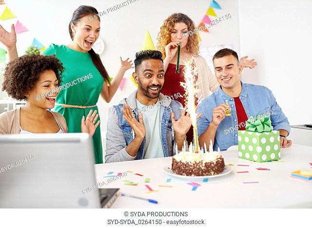 office team greeting colleague at birthday party