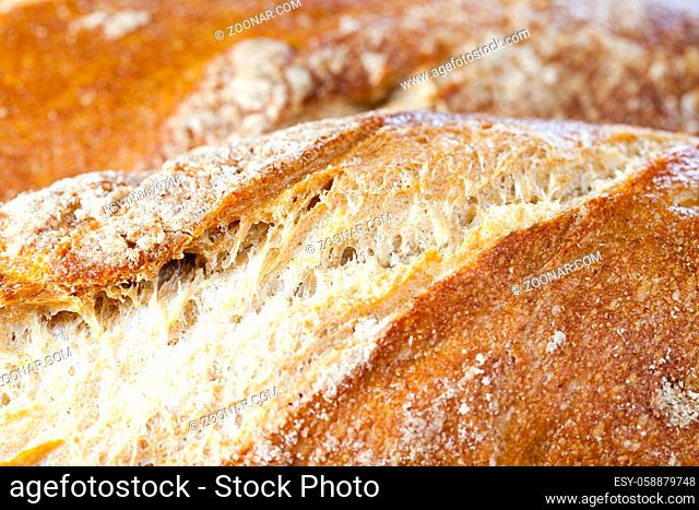 fresh light-colored bread with a delicious crisp, close-up in the kitchen