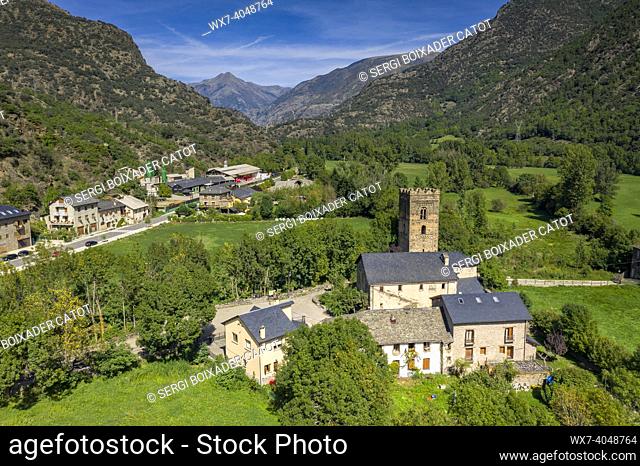 Aerial view of the Romanesque church of Santa Maria in Ribera de Cardós and the surrounding green fields in the Cardós valley (Pallars SobirÃ , Lleida