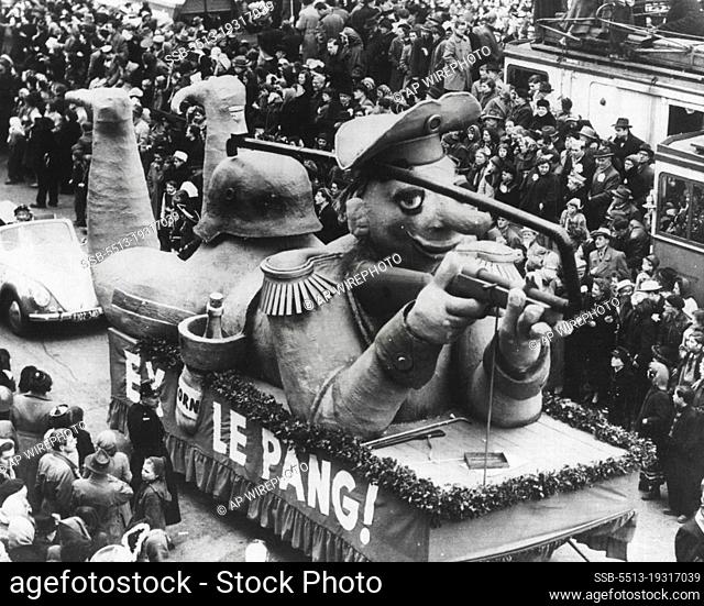 Teutonic Fun - If Hitler only could see this! Cologne's pre-Lenten Rose Monday carnival produced this float which depicts a raw recruit wearing a helmet in the...