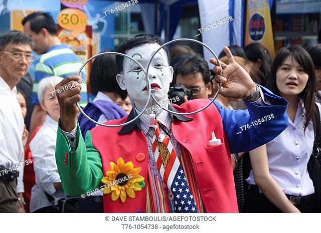 street performer doing tricks at the Silom Street Festival in Bangkok Thailand