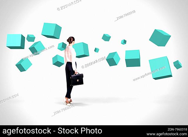 Business woman looking at turquoise cubes suspended in the air. Abstract isolated on white