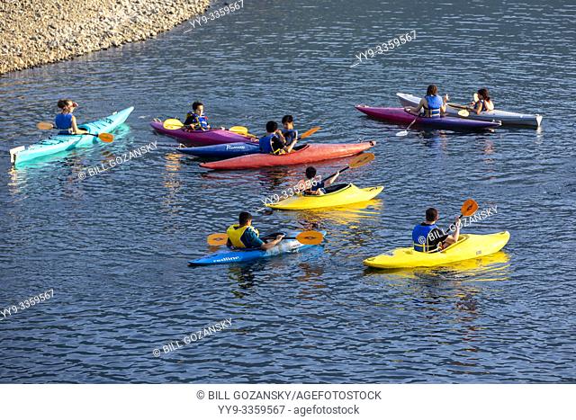 Group of children in colorful kayaks at Strathcona Park Lodge and Outdoor Education Centre in Strathcona Provincial Park, near Campbell River, Vancouver Island