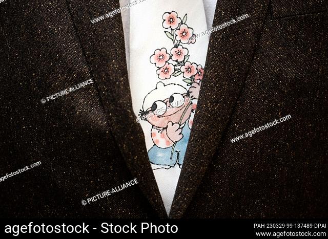 29 March 2023, Rhineland-Palatinate, Mainz: Stefan Thies, producer and managing director of NFP Animation, wears a tie with a Mainzelmännchen before the opening...