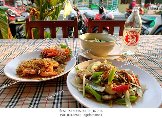 Various Thai dishes such as prawns in tamraind sauce (l) and beef with chilli and vegetables seen on a table at a restauarant in Karon Beach