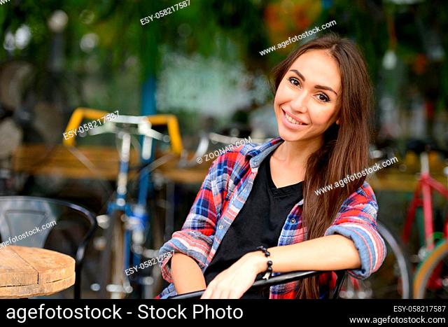 Portrait of young beautiful hipster woman in the city streets outdoors