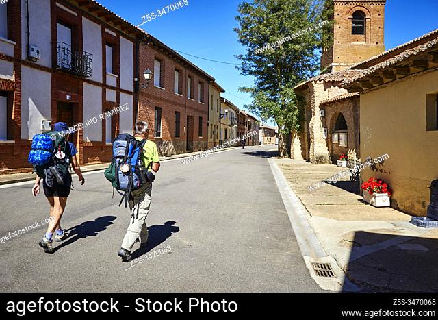 Pilgrims on the royal street - Calle Real. French Way, Way of St. James. El Burgo Ranero, León, Castile and Leon, Spain, Europe