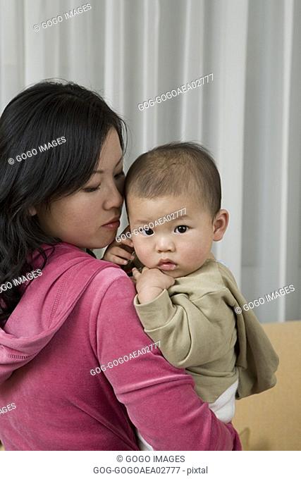 Baby looking over mother's shoulder