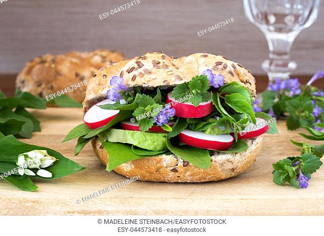 Vegetarian burger with ground-ivy, bear's garlic, dandelion and other wild edible plants