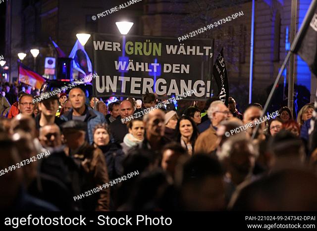 24 October 2022, Thuringia, Gera: ""If you vote green, you vote doom"" is written on a poster at a demonstration against the energy policy of the federal...