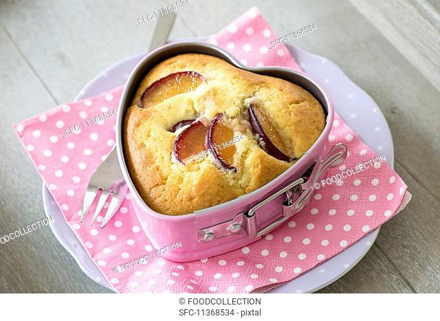 A plum cake in a heart-shaped baking tin