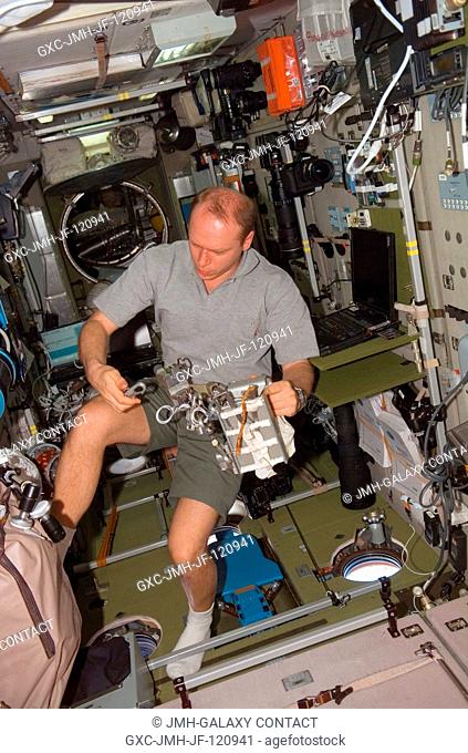 Cosmonaut Oleg V. Kotov, Expedition 15 flight engineer representing Russia's Federal Space Agency, works with an Orlan Tether Adapter assembly in the Zvezda...