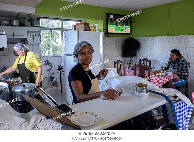 Angela Maria Carneiro Barbosa (front) and Antonia Lima (back) working in the restaurant Visual in the favela Rocinha, one of the biggest in Rio with 250