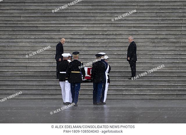 A United States Military Honor Guard carries the casket of former Senator John McCain, Republican of Arizona, up the stairs of the Capitol in Washington