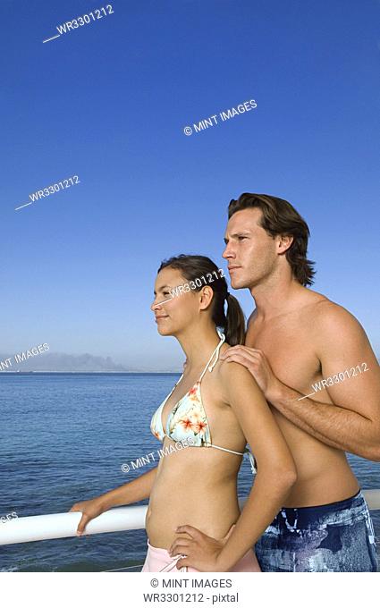Caucasian couple standing on boat deck