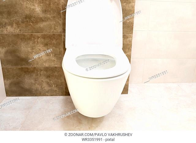 Close up of toilet bathroom interior with white ceramic seat