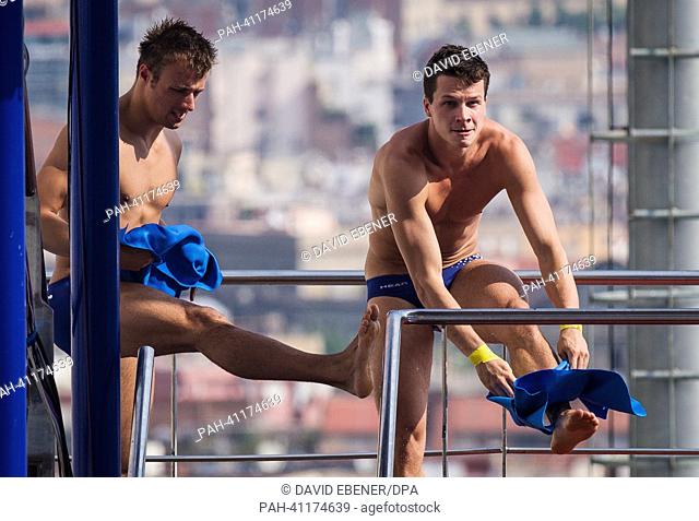 Sascha Klein (L) and Patrick Hausding of Germany prepare for a jump during the men's 10m Synchro Platform diving preliminaries of the 15th FINA Swimming World...