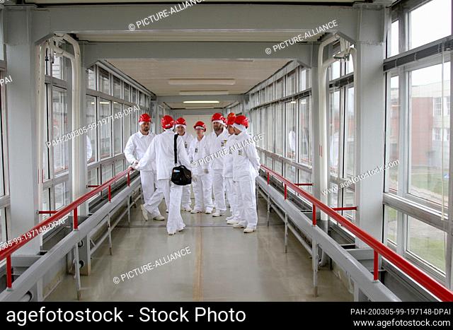 07 November 2019, Lithuania, Visaginas: A group of visitors listens to the explanations of the tour guide in a corridor of the decommissioned Ignalina nuclear...