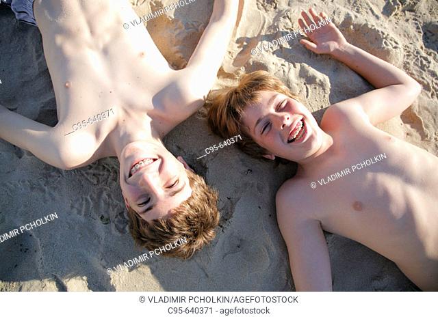 Virginia Beach, Virginia, USA, 2 boys playing on the beach, 13 years old