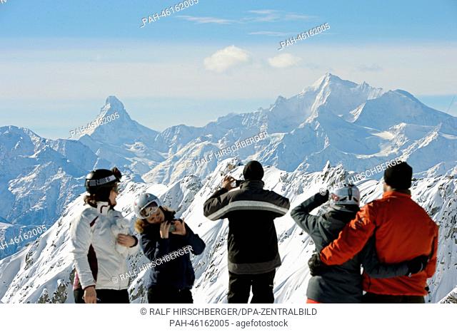 Tourists look at the Alps with the Matterhorn (L) from the 2, 900 meter high Eggishorn on a sunny day in Fiesch, Germany, 06 February 2014