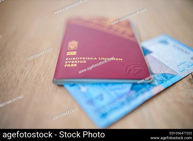 Picture of a Fifty Thousand Indonesian Rupees Bill partially inside a Sweden Passport