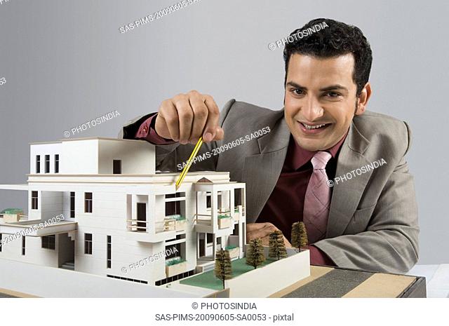 Architect with a model home in an office
